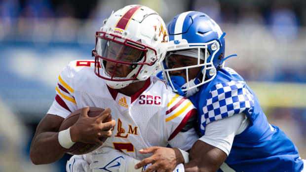 Kentucky Wildcats defensive back Moses Douglass (11) tackles Louisiana Monroe Warhawks Chandler Rogers (6) during the fourth quarter at Kroger Field.